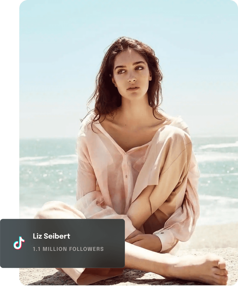 Instagram influencer sitting on the beach.